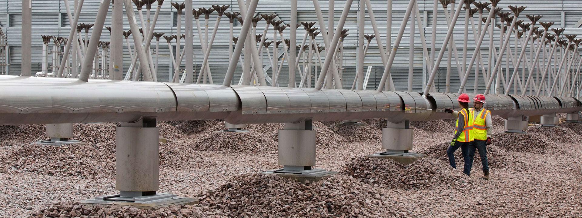 A man and a woman working on development of the Golden Triangle Polymers Company plant